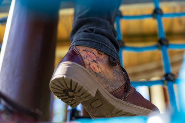 Wellington, New Zealand - April 06, 2024: Close-Up of Floral-Patterned Shoe on Playground Climbing Net
