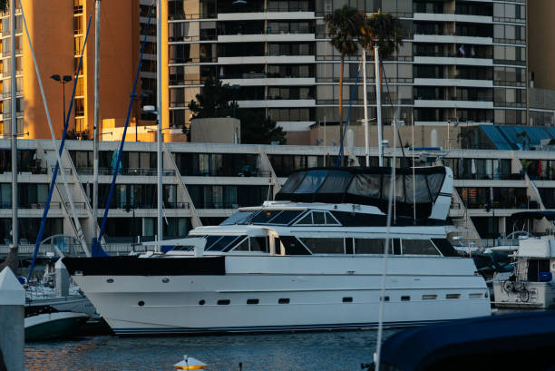 A sailboat glides back to the bustling marina, surrounded by yachts in Punta del Este, Uruguay.