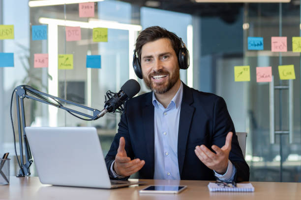 istock Professional podcast host in modern office setting with laptop and microphone 2174740768