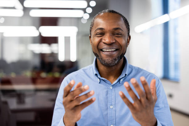 Happy man smiling in modern office setting, expressing positivity and joy during a successful video call