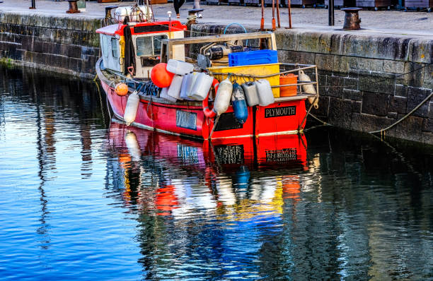 Colorful Red Fishing Boat Reflection Pier Inner Sutton Harbor Plymouth Devon England.
