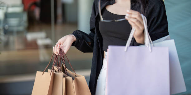istock Stylish Shopper Examining Pre Black Friday Purchases in Mall 2174750047