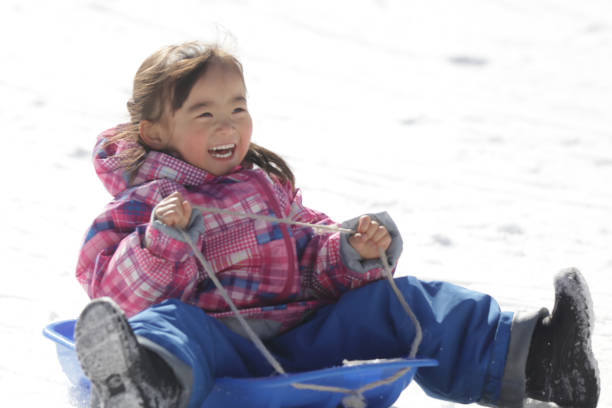 istock Girl playing with a sled 2174750944