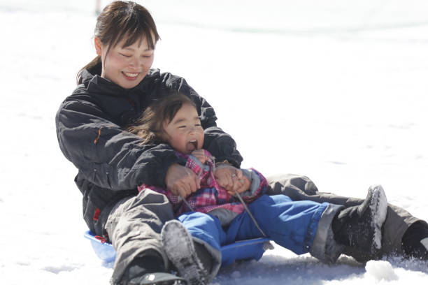 istock Parents and children playing on a sled 2174750961