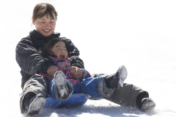istock Parents and children playing on a sled 2174750969