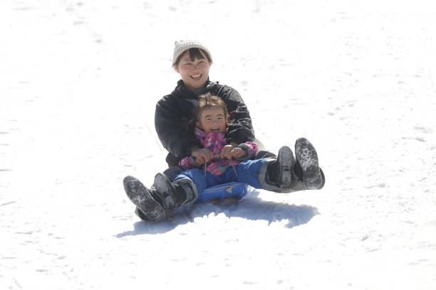 istock Parents and children playing on a sled 2174750976
