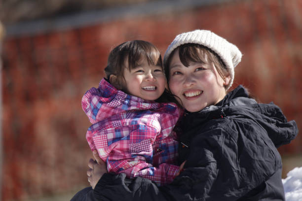 istock Parents and children playing in the snow 2174751143