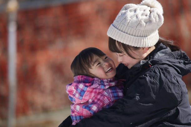 istock Parents and children playing in the snow 2174751150