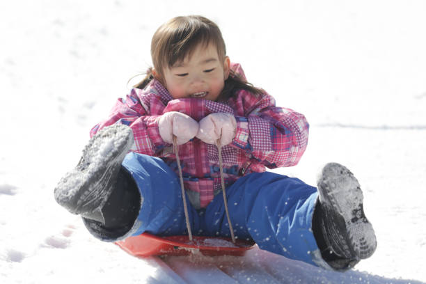 istock Girl playing with a sled 2174751386