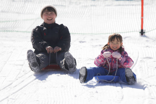 istock Parents and children playing on a sled 2174751424