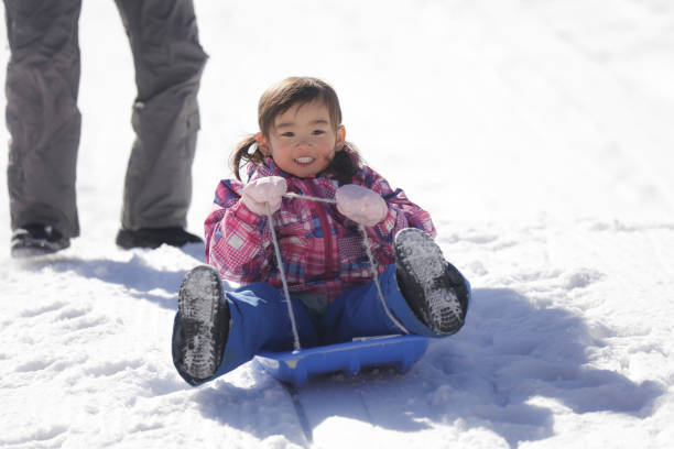 istock Parents and children playing on a sled 2174751427