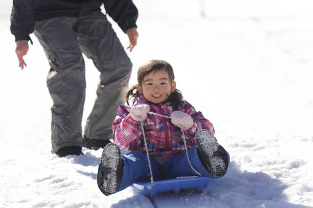 istock Parents and children playing on a sled 2174751440