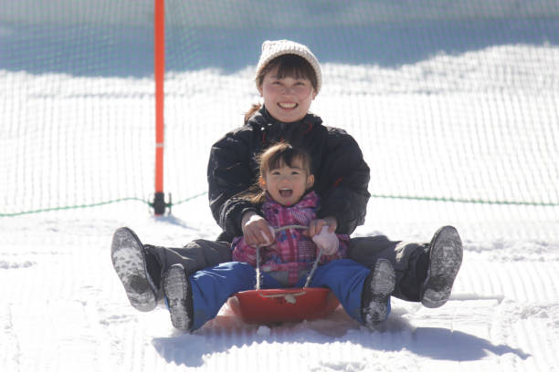 istock Parents and children playing on a sled 2174751458