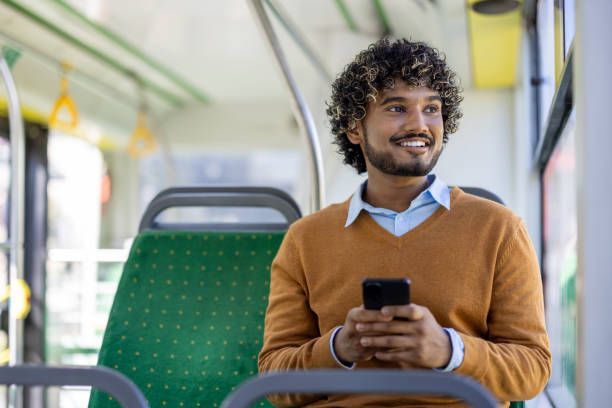 istock Happy man using smartphone while traveling in public transport, enjoying a pleasant commute on city bus 2174751533