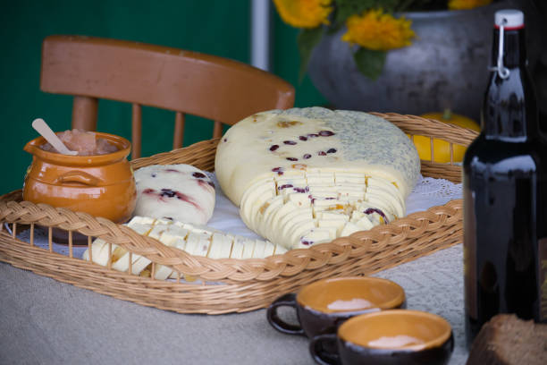 istock Assorted sliced cheeses with honey and cups on a table 2174753060