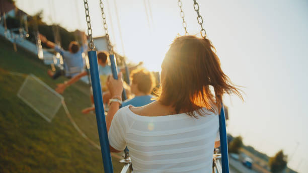 istock Joyful Carousel Ride with Mid Adult Woman 2174755643
