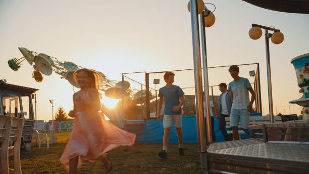 istock Cheerful Family Enjoying Amusement Park Outing at Dusk 2174755685