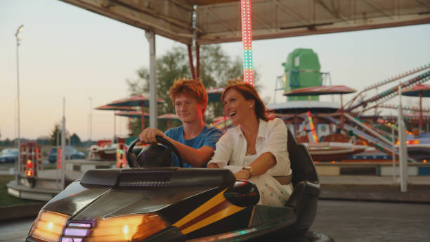 istock Joyful Mother and Son Enjoying Bumper Car Ride 2174755753