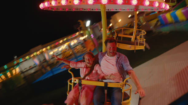 istock Joyful Caucasian Father and Daughter Riding Carousel Swing 2174755821