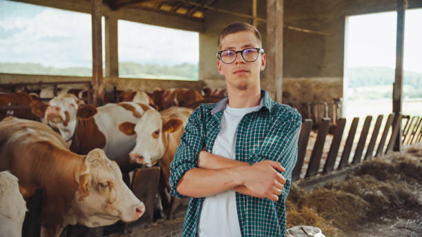 istock Caucasian Farmer Standing Confidently in Cow Barn 2174755870