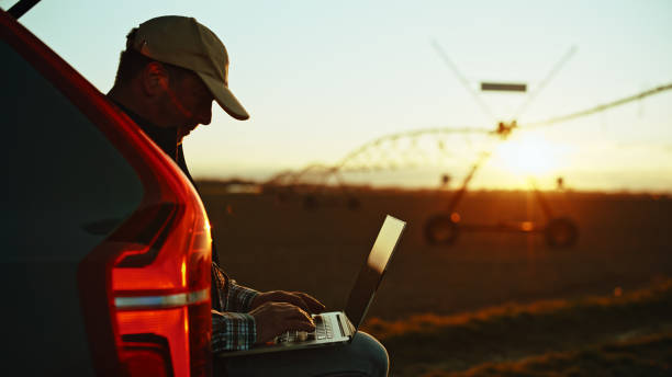 istock Technology Meets Agriculture: Farmer with Laptop at Dusk 2174757606