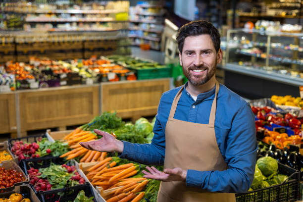 istock Friendly grocer displaying fresh organic vegetables in a vibrant grocery store setting filled with healthy produce and colorful selection 2174757614