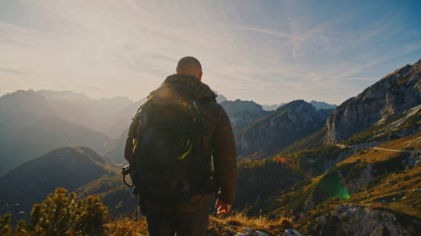 istock Caucasian Hiking Duo Rests with Mountain Vista 2174757721