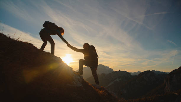 istock Energetic Couple Celebrates a Sunset Hike with a High Five 2174757730