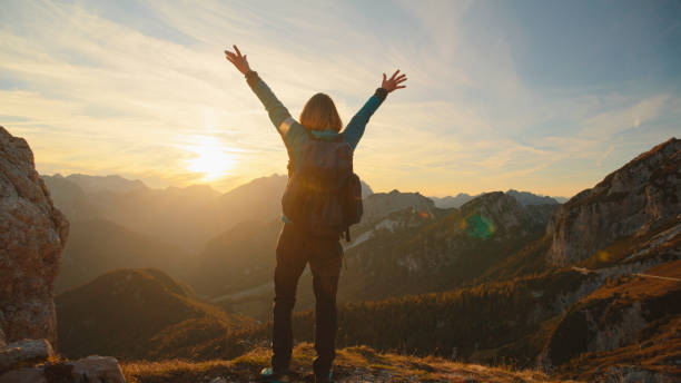 istock Joyful Mid-Age Female Hiker Celebrates Atop Mountain 2174757733