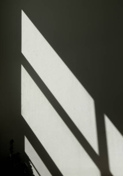 istock shadow on the wall of a room with a light from the window 2174757771
