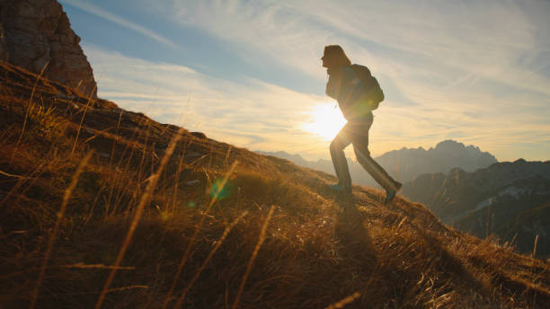 istock Resolute Female Hiker Ascending Trail at Dusk 2174757776