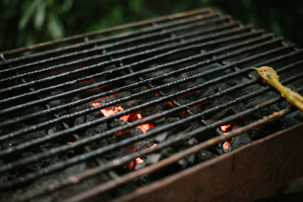 This image showcases three distinct barbecue grills neatly arranged and isolated on a clean white background, grounded by a strip of green grass at the base. The cutout style makes it incredibly versatile for various design projects. Perfect for illustrating themes related to summer cookouts, backyard parties, outdoor entertaining, grilling, food preparation, and leisure activities. Ideal for use by food brands, supermarkets, grill manufacturers, lifestyle blogs, event planners, or any content focusing on outdoor dining and social gatherings.