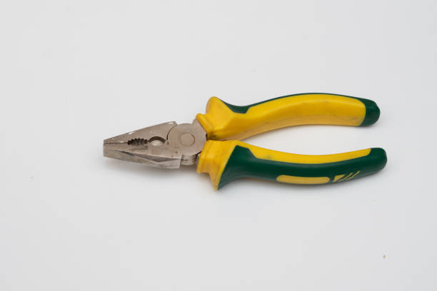 a yellow pair of pliers is placed on a white base