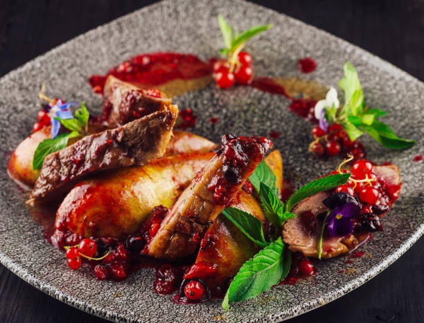 istock Roasted duck breast with pear and red currant sauce on plate 2174769306