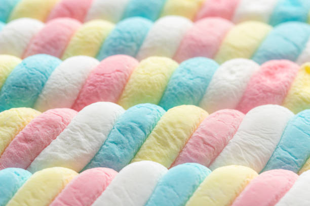 Focus on group of colourful stripes of sour candy in retail display