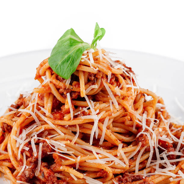istock Delicious spaghetti bolognese with basil leaf topping being served on white plate 2174769787