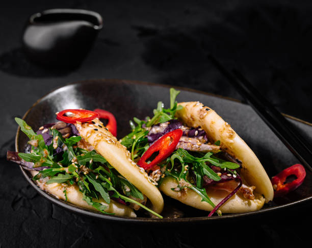 Exquisite asian bao bun filled with vegetables and meat, garnished with sesame seeds