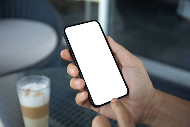 istock male hands holding phone with isolated screen background table coffee 2174774271