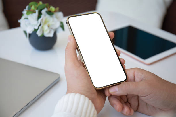 istock male hands holding phone with isolated screen background white table 2174774289