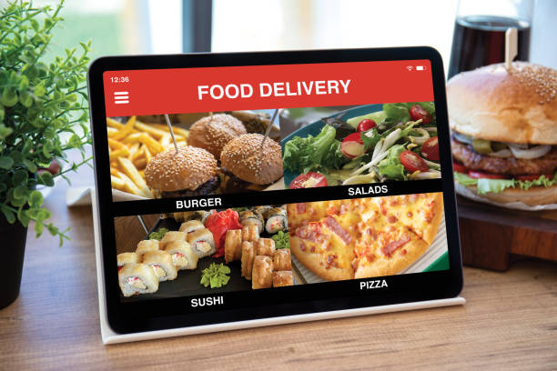 computer tablet with app food delivery on screen in cafe