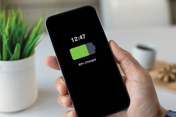istock men hand holding phone charged battery on screen in cafe 2174774317