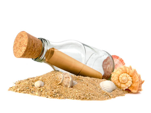 istock Bottle with a message on pile of sand isolated on white background, Side view 2174781787