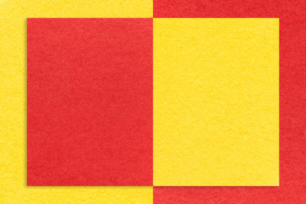 Texture of red and yellow paper background with geometric shape and pattern, macro. Structure of craft cardboard with frame. Felt abstract backdrop closeup.
