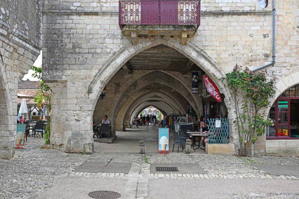 Monpazier, France: 15 July 2024: The arcades next to the town square in the bastide town of Monpazier in the Domme