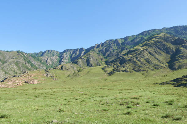 istock Mountain landscape with green grass and blue sky. 2174791059