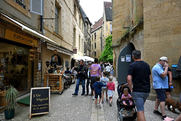 Sarlat, France 22 July 2024: Shoppers and tourists on Rue des Consuls in the town of Sarlat