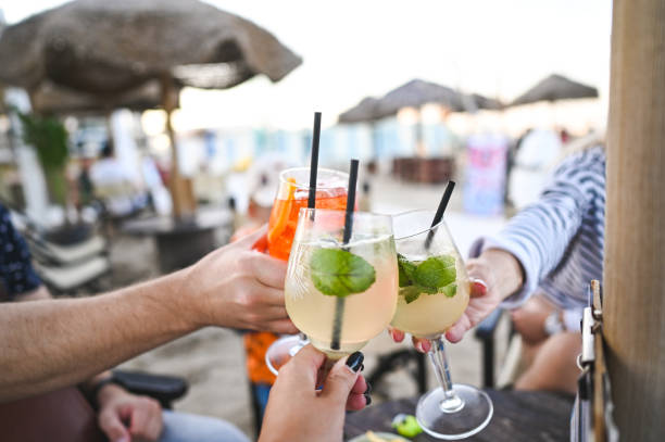 istock friends toasting at beach restaurant. 2174797826