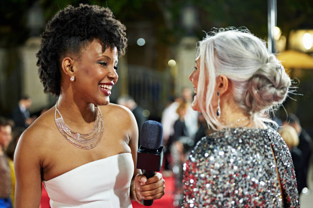 istock Entertainment correspondent enjoying talk with celebrity 2174800194