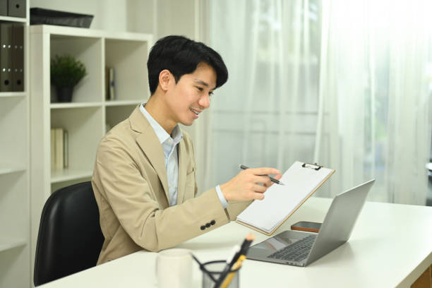 istock Young businessman having video conference or presentation via laptop 2174800548