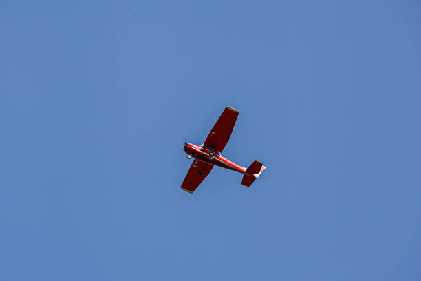istock Single piston aircraft. Single-propeller aircraft flying over the blue sky. Single turboprop aircraft.. Small private plane flying in blue clouds. 2174806229